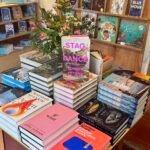 Stag Dance book on table of books in bookshop.